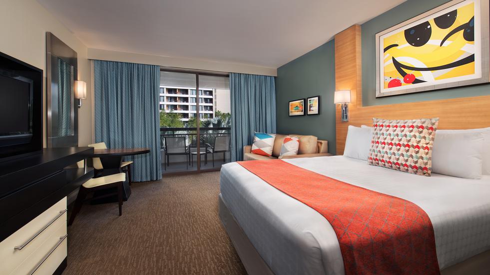 Disney contemporary resort room with one king bed, tv, dresser, and balcony