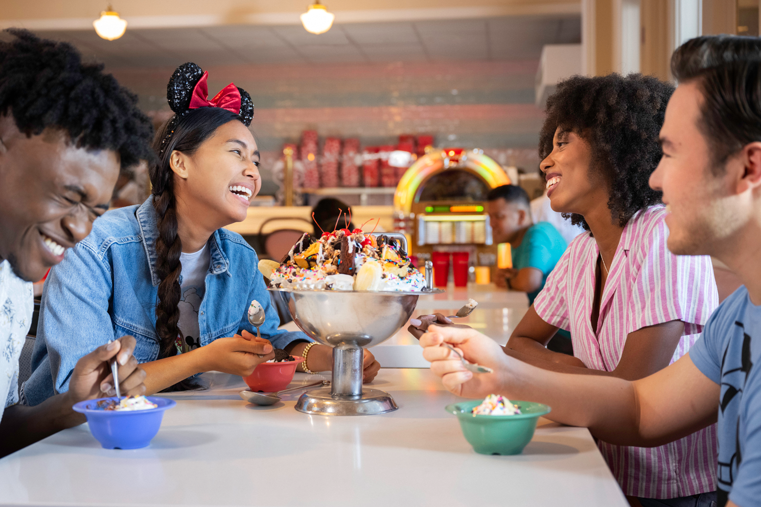 Friends sharing a bowl of ice cream at Disney
