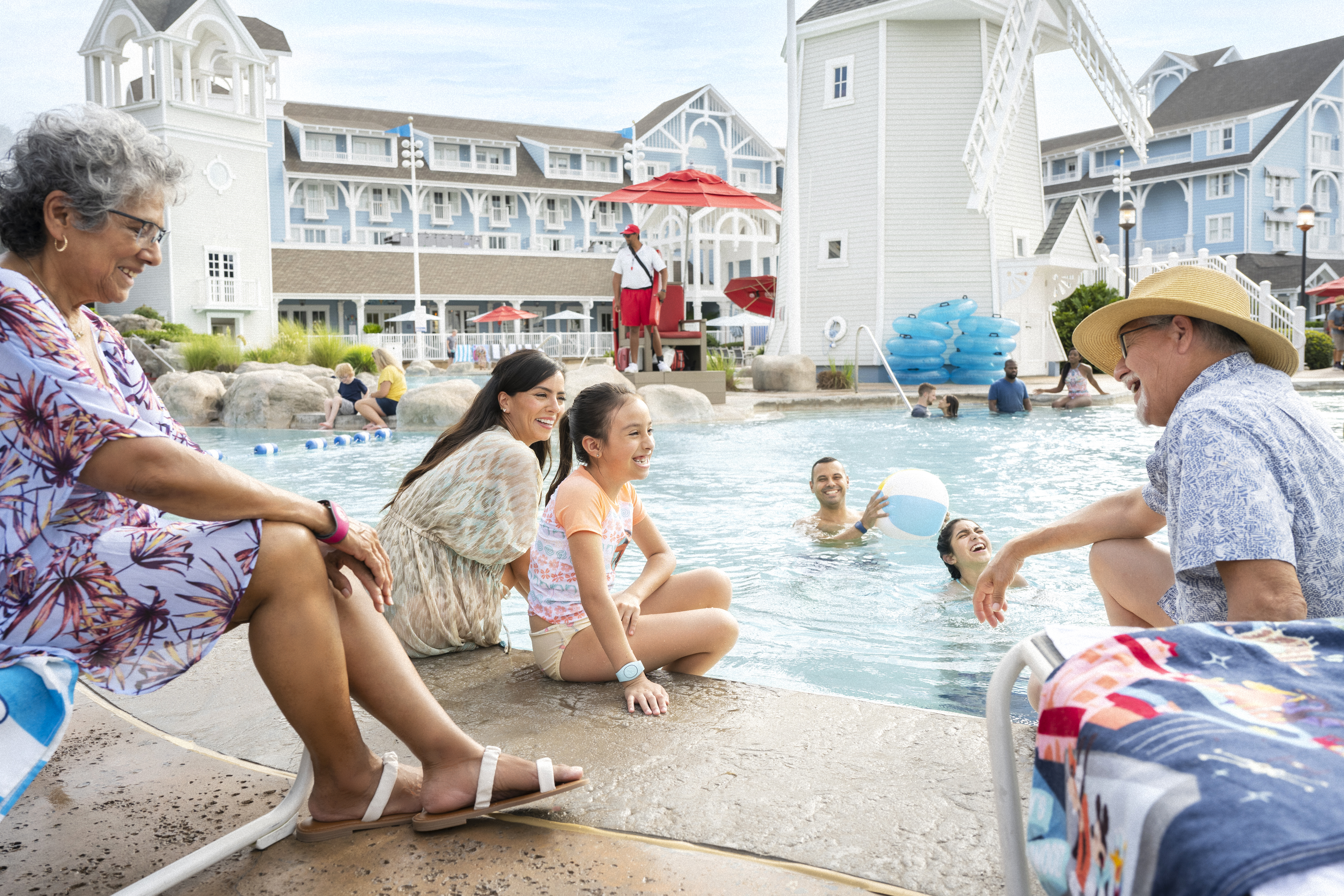 A family enjoying time by the pool at the Yacht Club