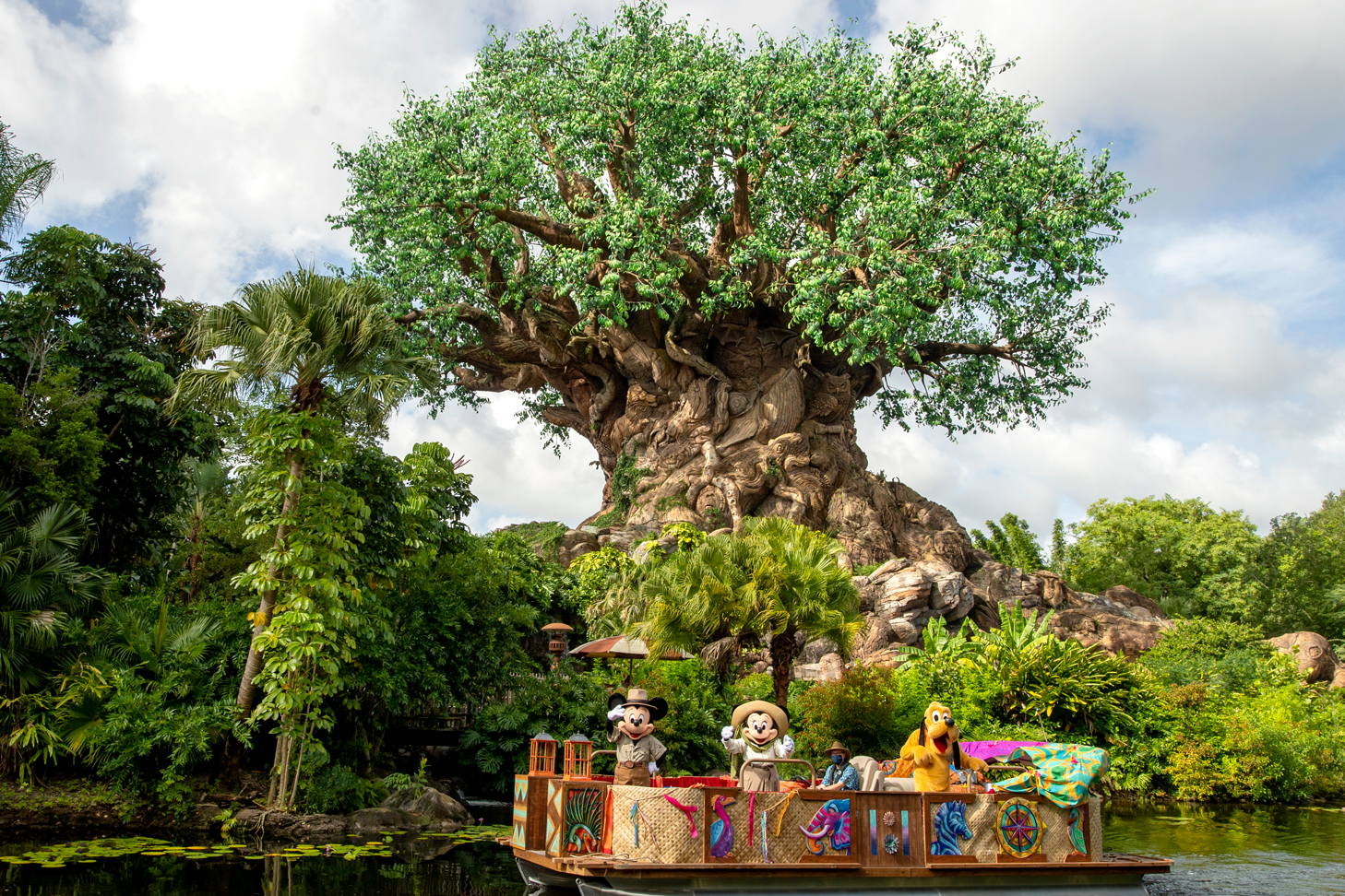 Disney characters in front of Magic Tree