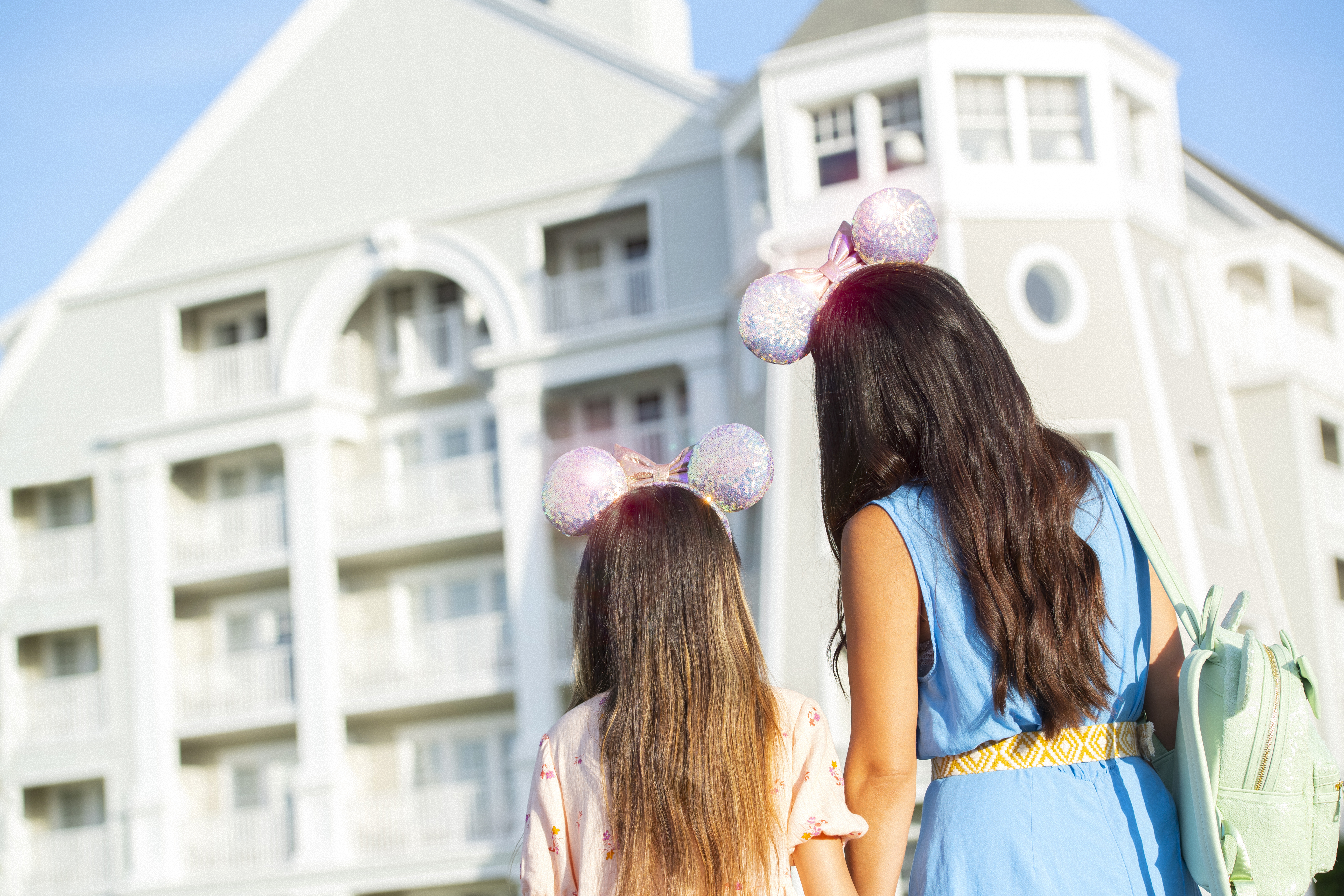 Mom and daughter standing in front of Disney Yacht Club