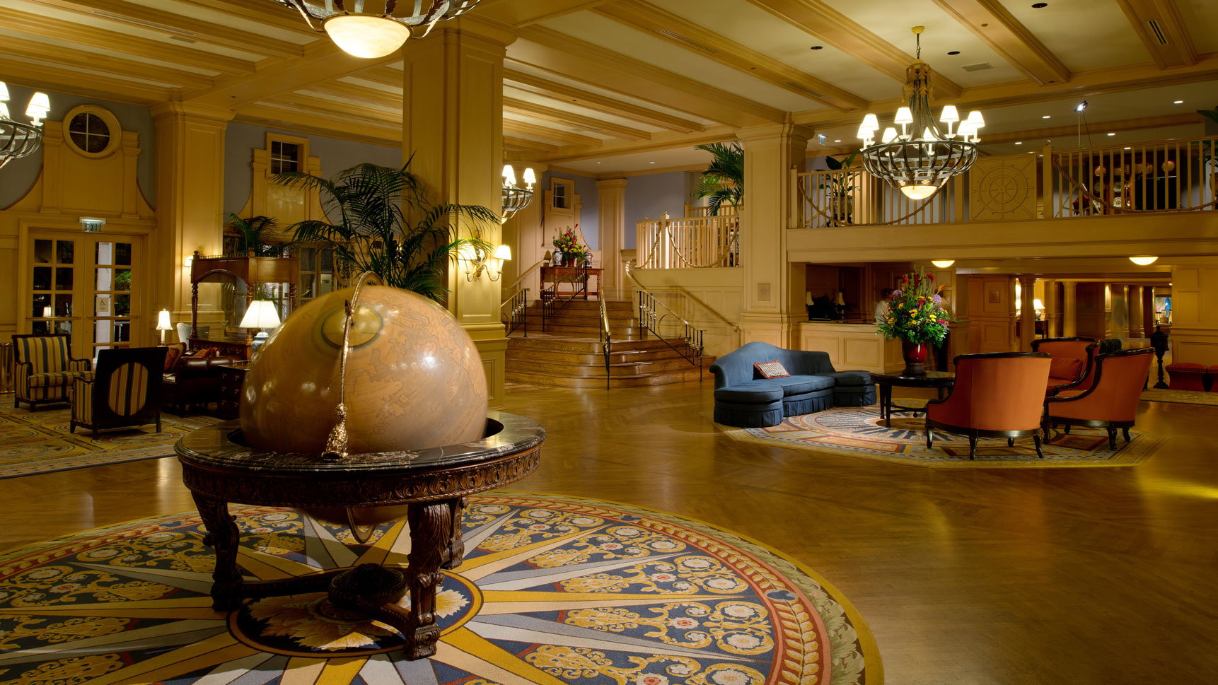 Yacht club lobby featuring large globe and seating areas