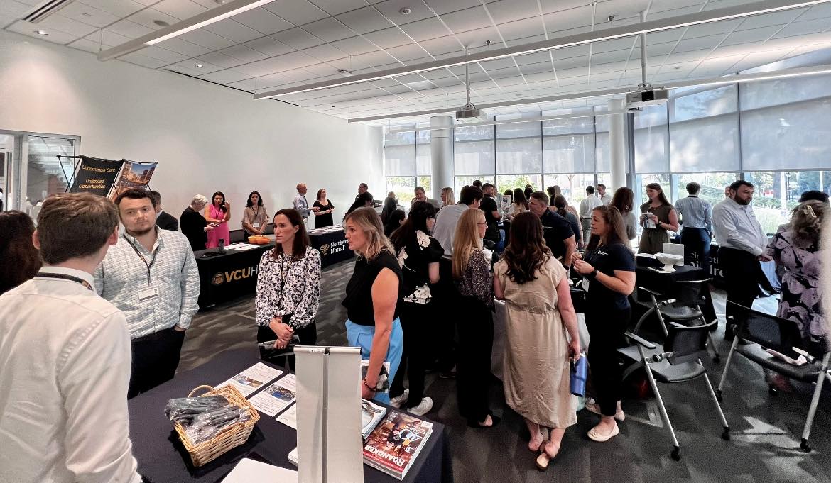 Students and faculty visiting tables for professional development day.