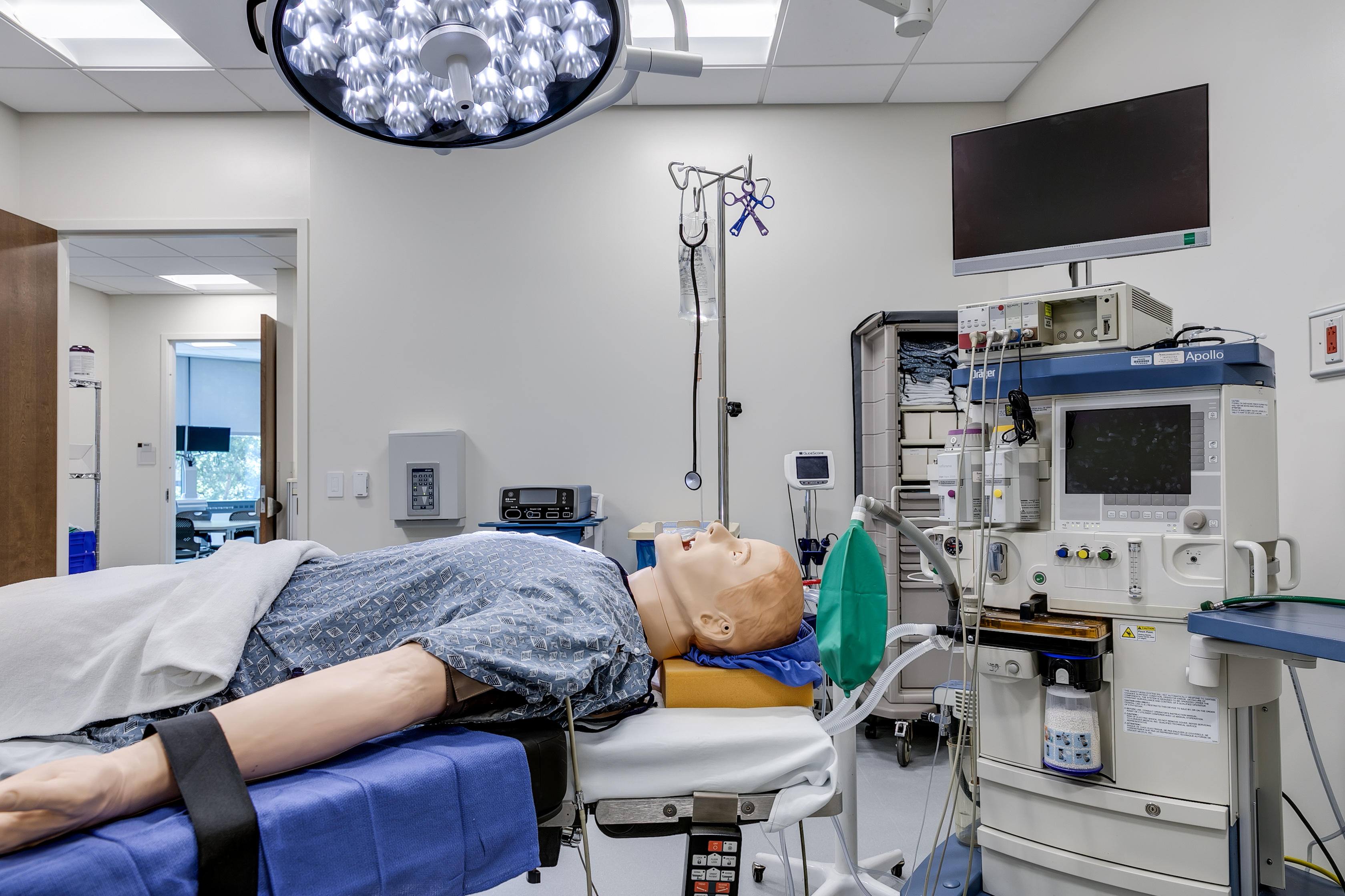 Simulation room with simulation mannequin surrounded by anesthesia machines