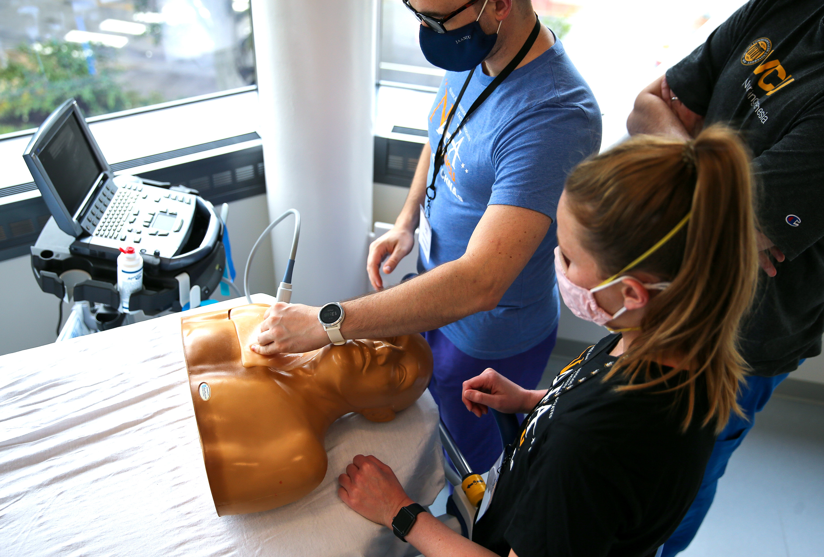 Students practicing ultrasound techniques on simulation mannequin